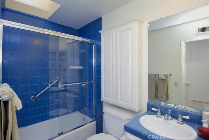 Hall bath skylight (can be tilted up for extra ventilation), additional storage cabinetry & water conserving commode