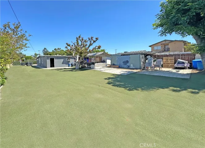 Manicured Shade Trees, Concrete Open Patio, and Multiple Storage Sheds