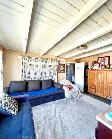 Living Room has Vaulted Open Beam Ceiling
