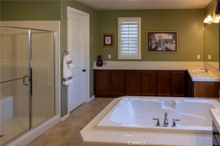 Primary bathroom offers His and Her closets.