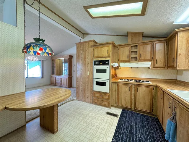 Includes A Four-Burner Gas Range, And An Exhaust Hood