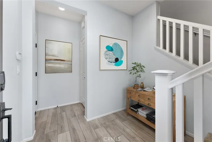 Foyer virtually staged. There is a deep closet here and door to enter garage.
