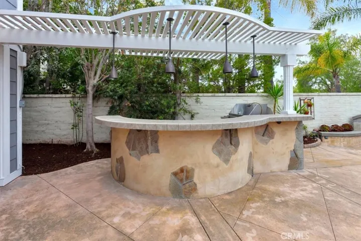 Covered BBQ Island with ample bar space for entertaining.