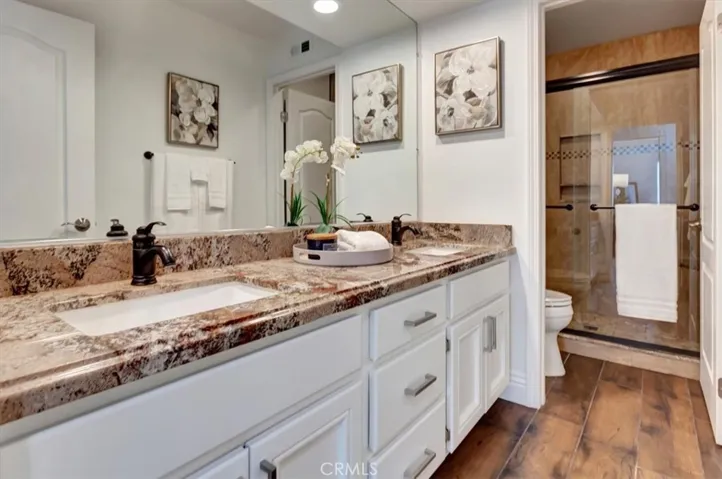 Updated upstairs hall bath with dual vanity, granite counters & updated tile shower surround.