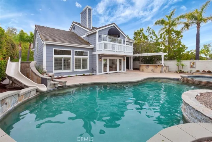 Custom saltwater pool, spa, waterslide, fire pit, & built-in BBQ area.