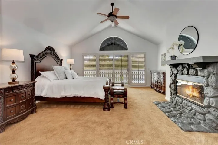 Unwind in the grand primary suite featuring a fireplace, a balcony overlooking the views, & an ensuite bath.