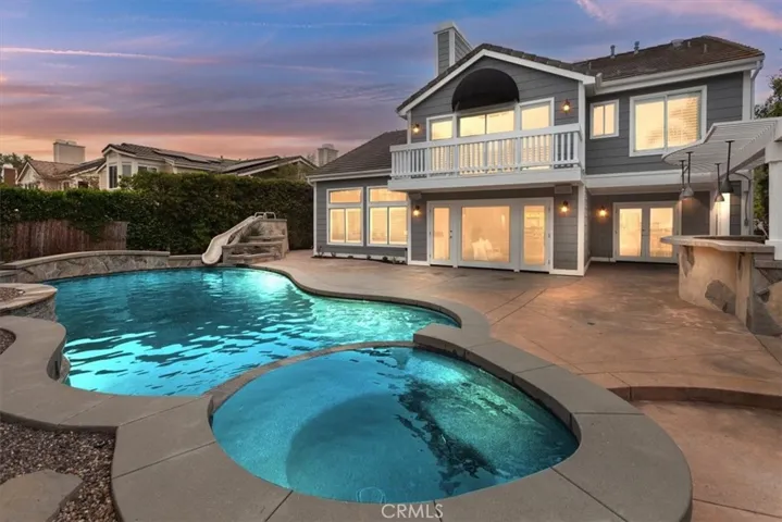 Imagine hosting unforgettable gatherings in your expansive backyard oasis, complete w/custom saltwater pool, spa, waterslide, fire pit, & built-in BBQ area.