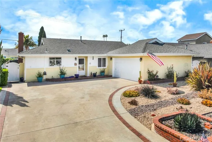 Beautiful Curb Appeal with Sweeping Driveway to a Finished Garage and Drought Tolerant Landscaping