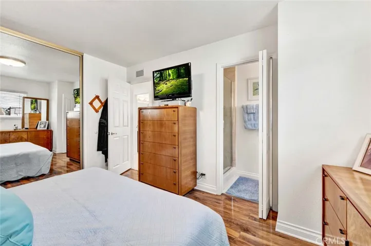 Master Bedroom With 6 Panel Door And Laminate Flooring