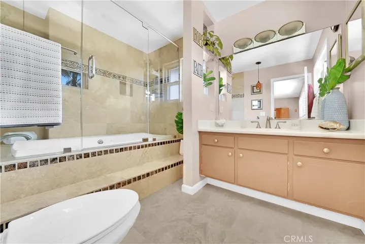 Upgraded bathroom with a huge soaking tub and dramatic glass doors, offering a spa-like experience in the comfort of your own home.