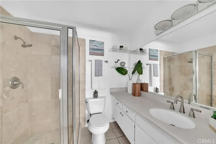 The downstairs bathroom features brand new shower enclosure w/ tiled surrounds & glass doors, adding a touch of modern elegance.
