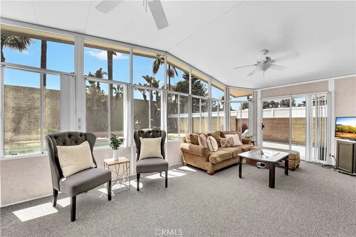 Step into the custom-added Arizona room, boasting vaulted ceilings, two ceiling fans, and an abundance of windows overlooking the lush backyard oasis.
