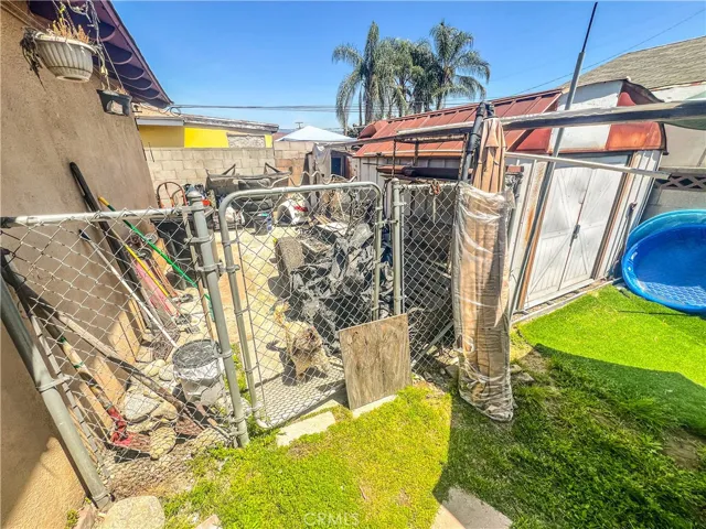 Back to side yard with sheds-fenced