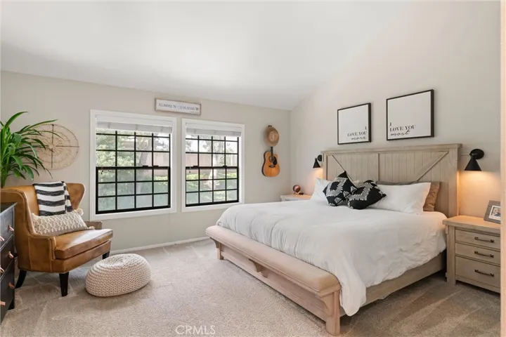 Primary bedroom with natural lights and vaulted ceilings