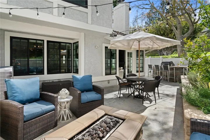 Firepit with sitting areas,  built in BBQ, and fruit trees.