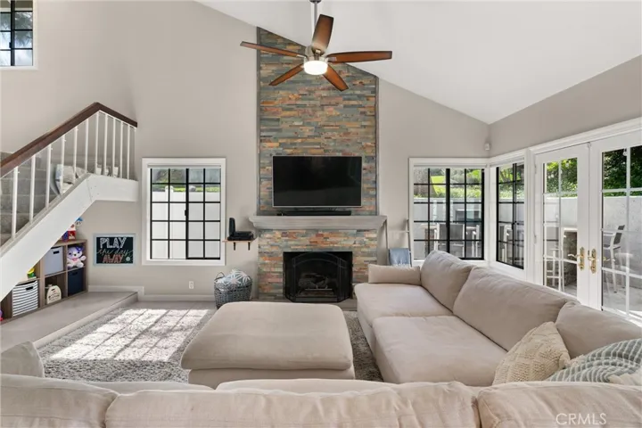 Living room with vaulted ceilings and fireplace