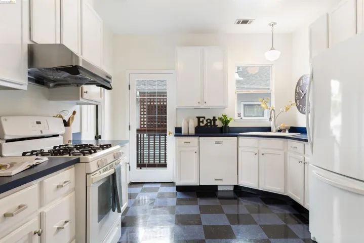 Laminate counters, marmoleum floors, side entrance to the yard.