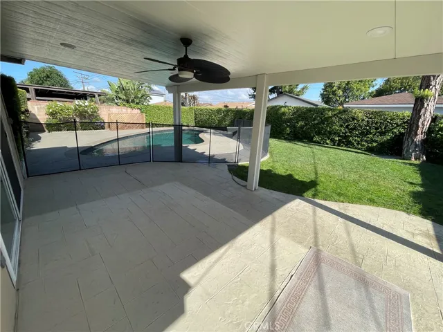 Fenced pool with large covered patio