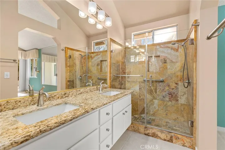 Upgraded shower, dual sinks, flooring and lighting.