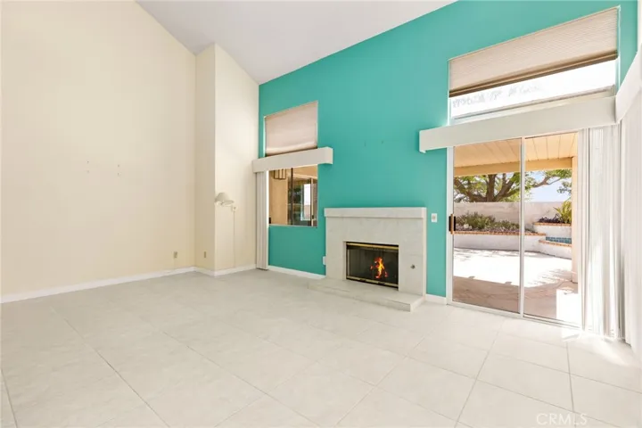 Family Room with blinds on higher windows that open and close with ease
