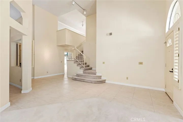 Entry with front door at far right, Library to the left, Loft at top of stairs