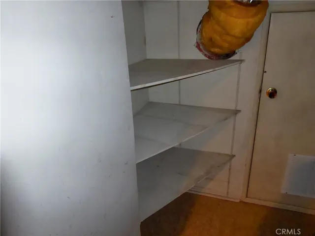 Walk-in Heater Room with extra storage & short door to Attic for possible storage.