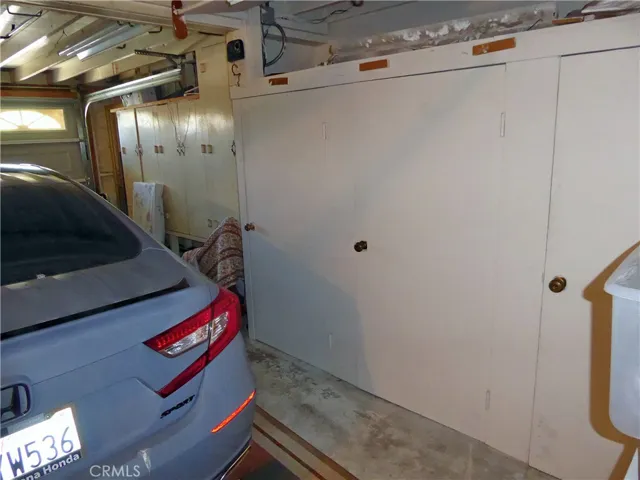 Laundry with Washer, Dryer, newer Water Heater, Sink & Cabinets.