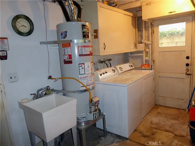 Laundry with Washer, Dryer, newer Water Heater, Sink & Cabinets.