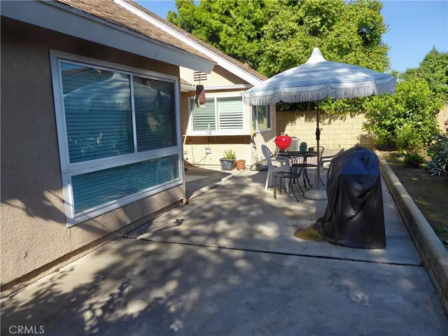 Patio across back of House with Large Garden & Planter.