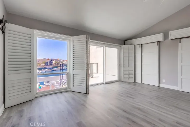 Master Bedroom with wood plantation shutters, barn door closet doors.