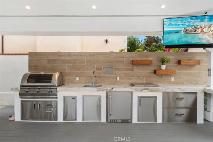 Outdoor kitchen with top of the line appliances, TV, surround sound
