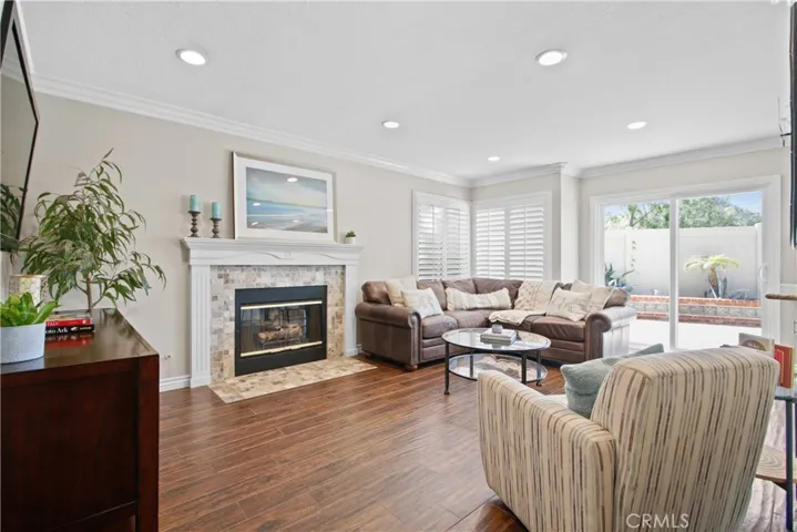 The cozy den w/ a gas fireplace.