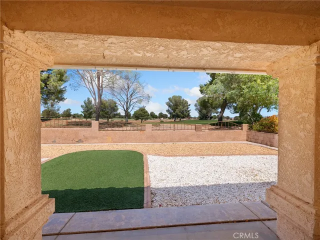 Covered patio gives access to virtually maintenance free back yard.