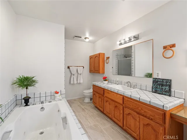 soaking tub and walk in cshower behind the wall.