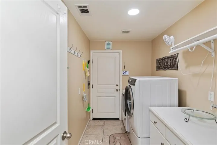 Downstairs Laundry Room with direct access to two-car garage.