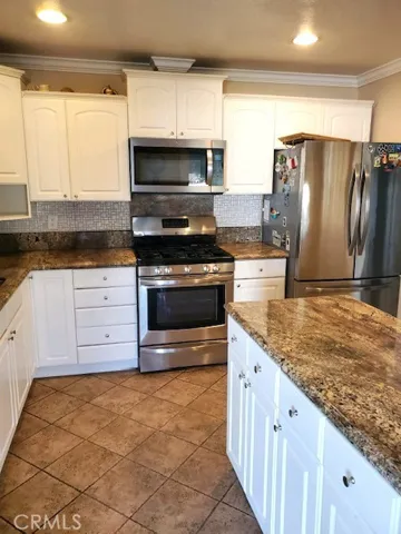 Kitchen with Tiled Floors, Granite Counters and Stainless Steel Appliances