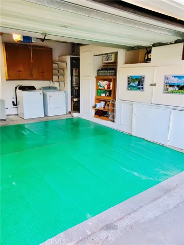Inside Garage view with W/D and Work Bench