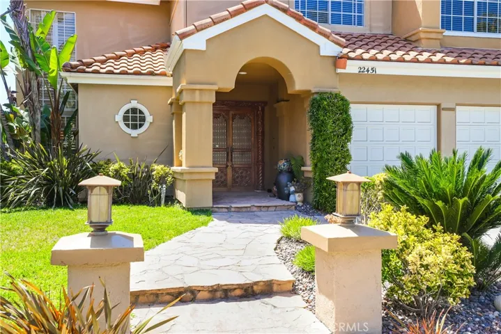 The beautifully lite lanterns and  stone pathway leads you to the front entry.