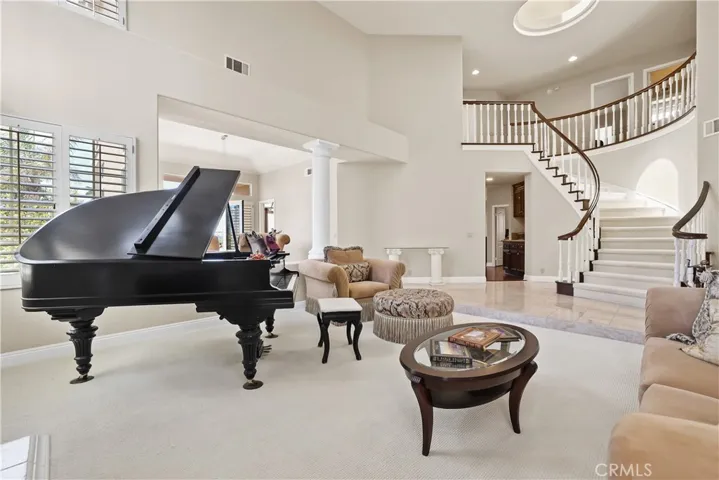 Spacious and Open Formal Living Room with views of Spiraling Staircase and Dome Skylight