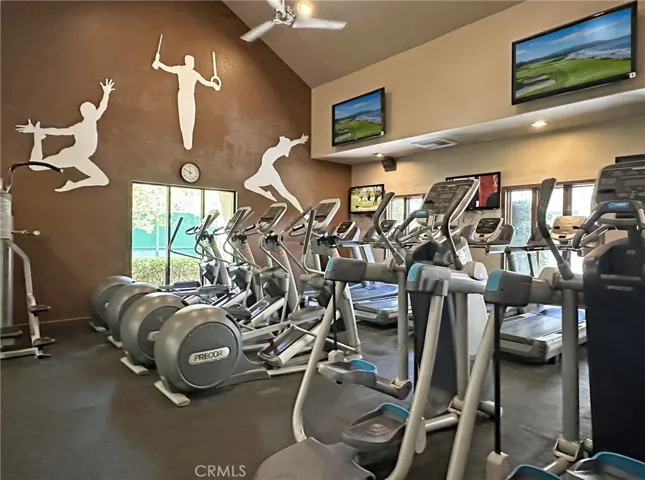 An Awesome Gym and workout room with TV's