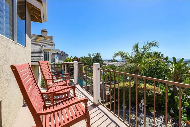Enjoy the panoramic and lake views from the Primary Bedrooms balcony.