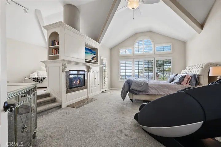 Primary Bedroom with its multi level ceilings and dual sided fireplace also serves the retreat area.  At the end of the day enjoy the door to the balcony with its awesome lake views.