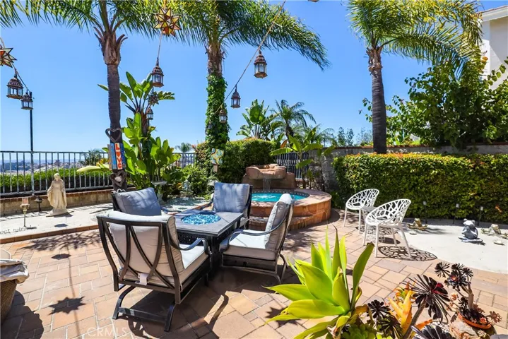 Mature palm trees and banana tree surround the spa with waterfall to create a serene place to relax