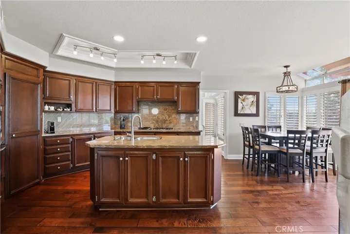 Lots of cabinets for storage, granite backsplash for easy cleaning and large pantry closet
