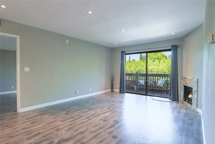 living room with recessed lighting, patio and fireplace