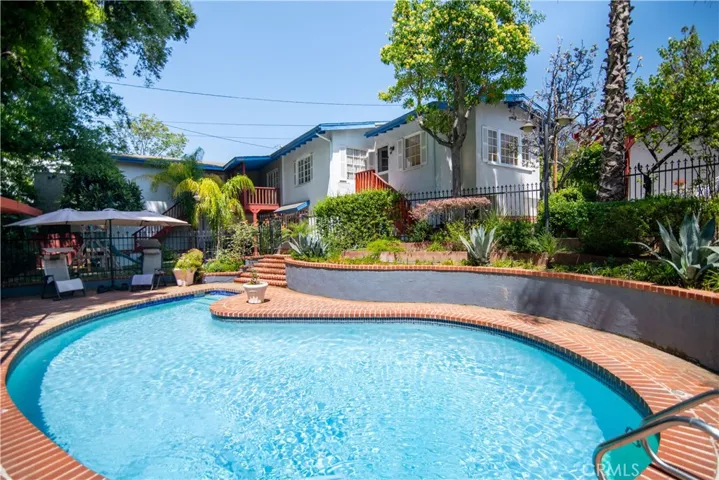 Rear view of home showcasing the sparkling pool