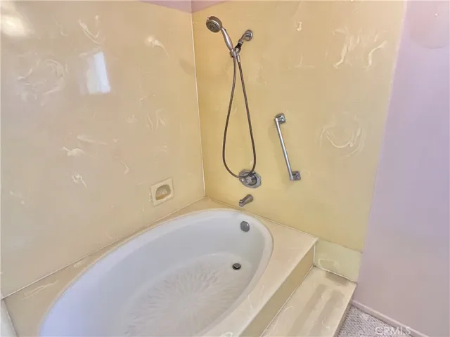 Primary bath has roman style tub and shower.
