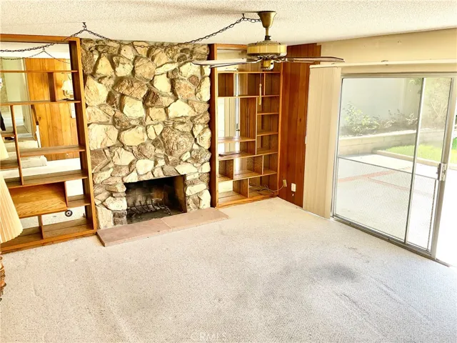 Family room with stone fireplace.
