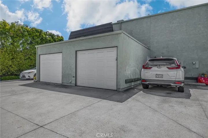 One single car garage and a parking space.