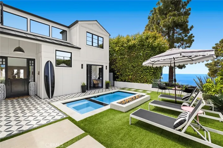 With timeless Modern Farmhouse architecture, bespoke appointments, high-end finishes and intimate ocean views, this custom home is among the finest in Laguna Beach.